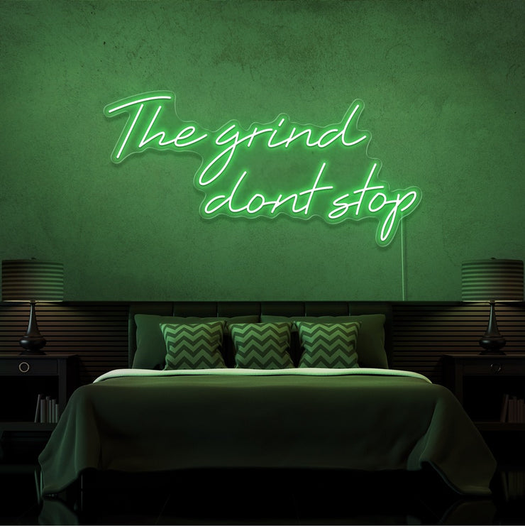 greenthe grind dont stop neon sign hanging on bedroom wall