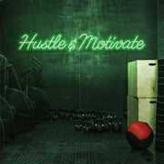 green hustle and motivate neon sign hanging on gym wall