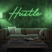 green hustle neon sign hanging on living room wall