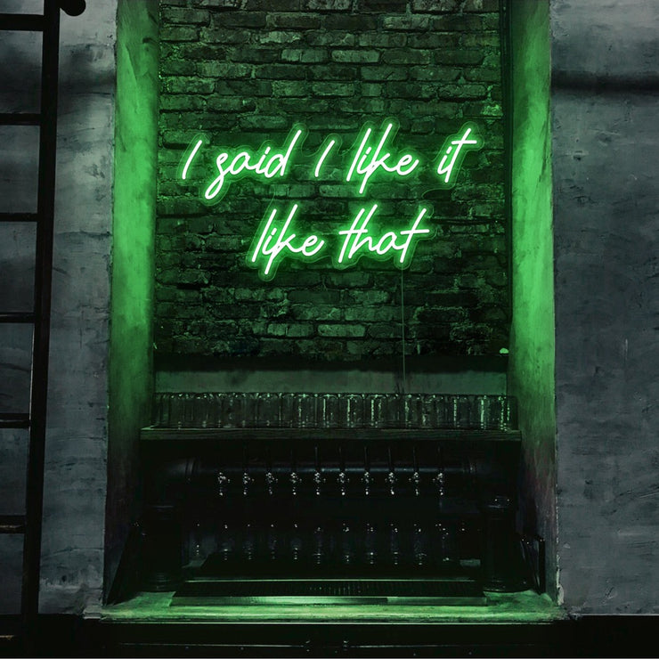 green i said i like it like that neon sign hanging on bar wall