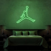 green jordan jumpman neon sign hanging on bedroom wall