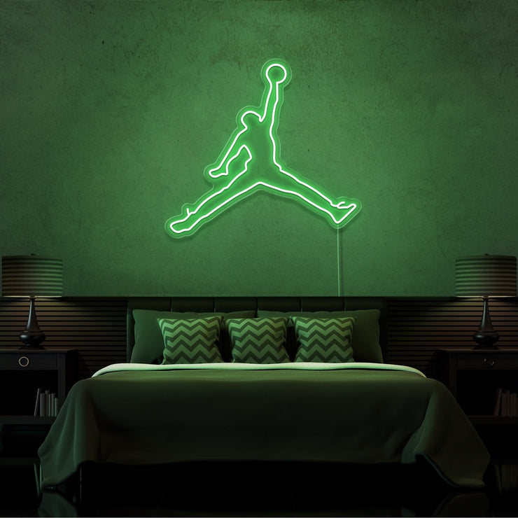 green jordan jumpman neon sign hanging on bedroom wall