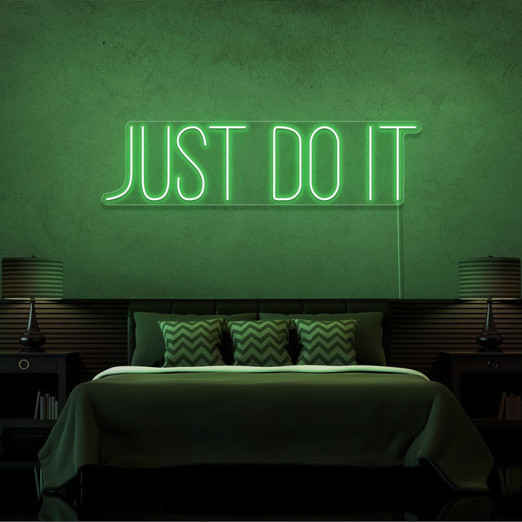 green just do it neon sign hanging on bedroom wall