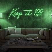 green keep it 100 neon sign hanging on living room wall