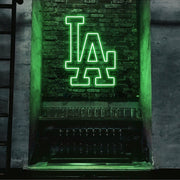 green LA neon sign hanging on bar wall
