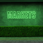 green markets neon sign hanging on outside wall