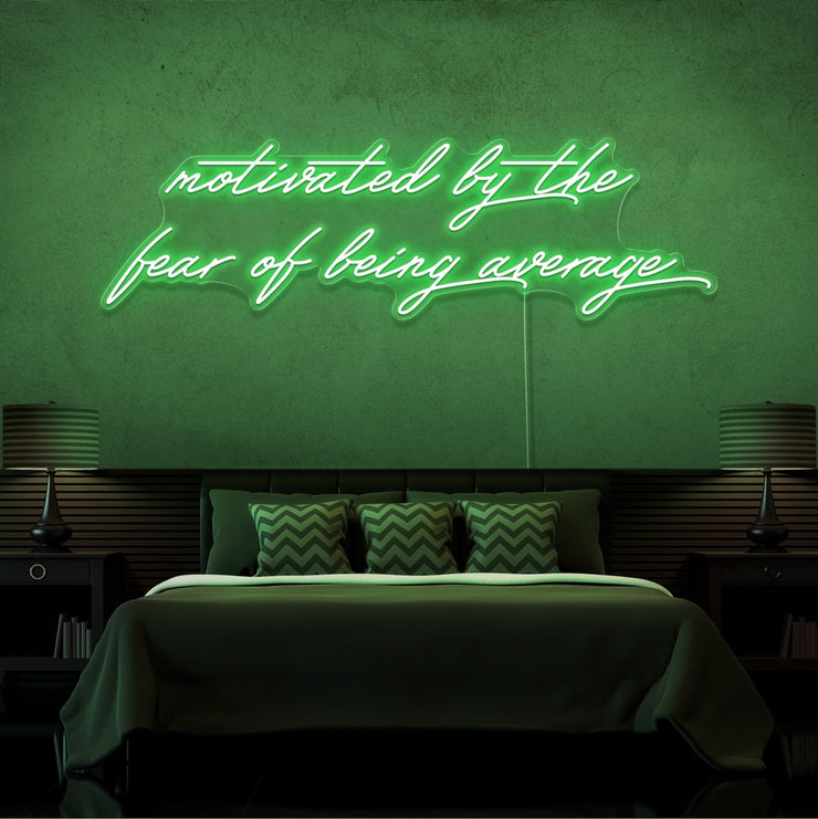 green motivated by the fear of being average neon sign hanging on bedroom wall