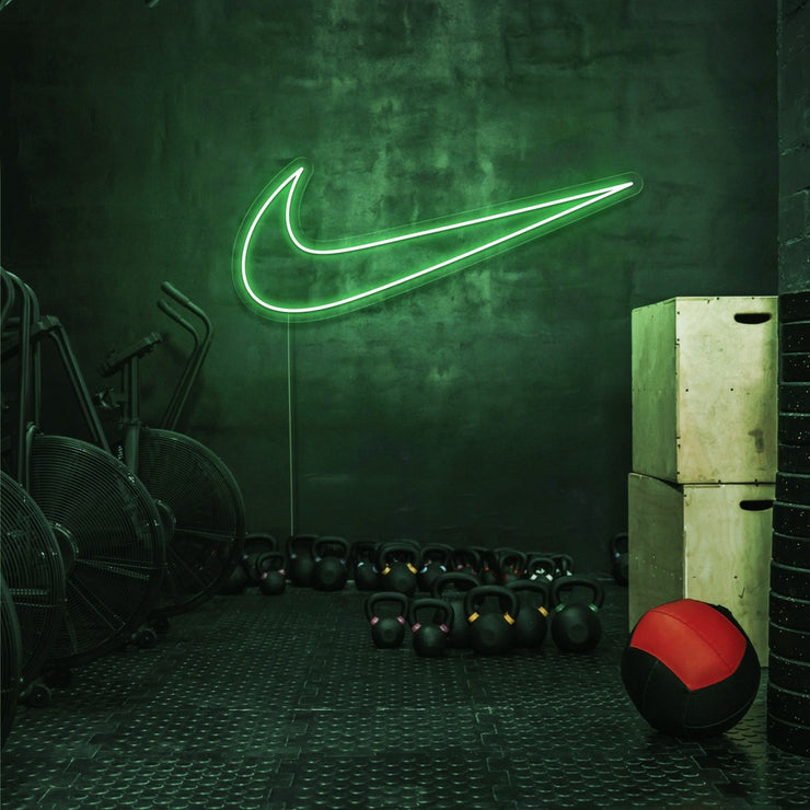 green nike swoosh neon sign hanging on gym wall