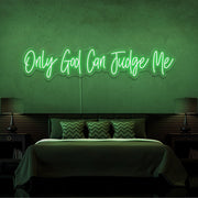 green only god can judge me neon sign hanging on bedroom wall