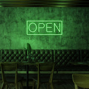 green open neon sign hanging on cafe wall