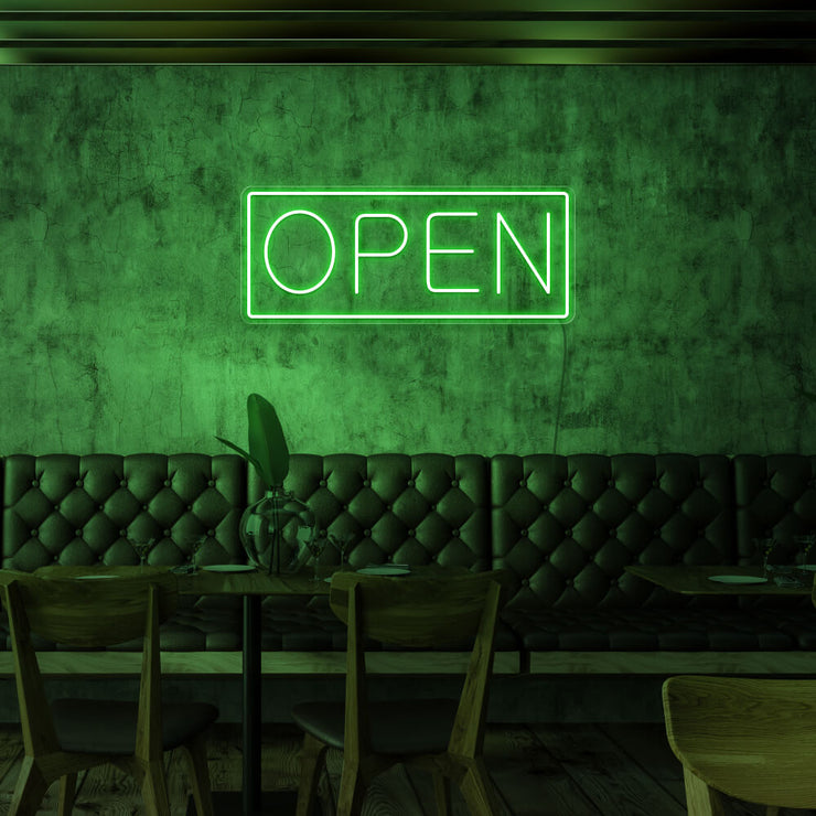 green open neon sign hanging on cafe wall