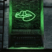 green smoking lips neon sign hanging on bar wall