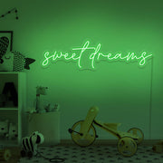 green sweet dreams neon sign hanging on kids bedroom wall