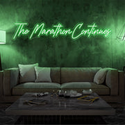 green the marathon continues neon sign hanging on living room wall