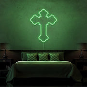 green tupac cross neon sign hanging on bedroom wall