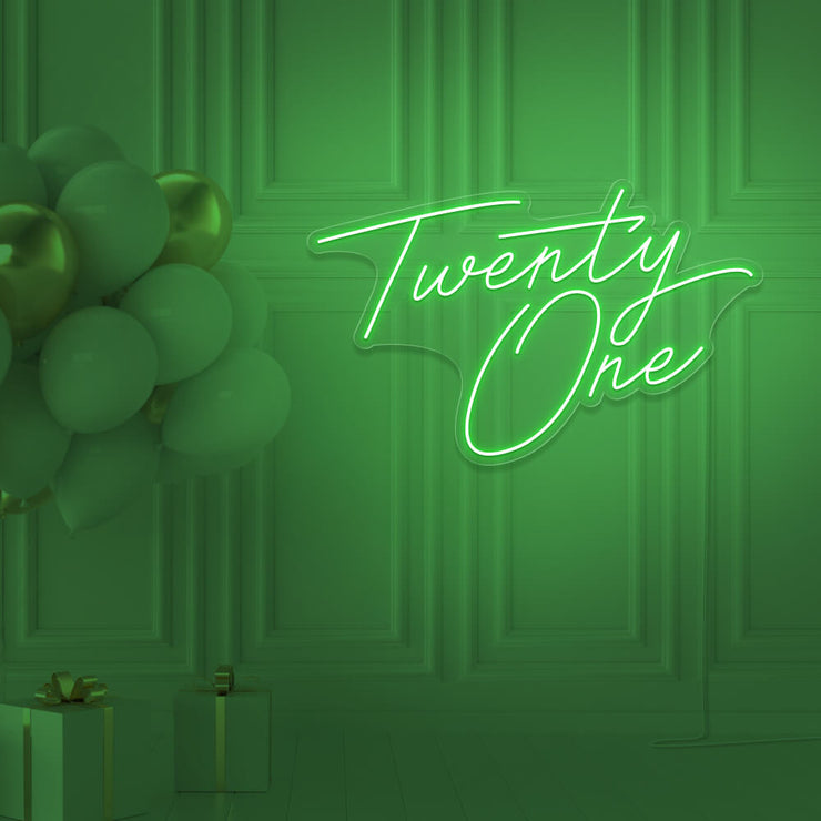 green  twenty one neon sign hanging on wall with balloons
