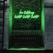 green im talking wap wap wap neon sign hanging on bar wall