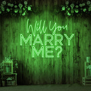 green will you marry me neon sign hanging on timber wall