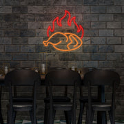 orange hot chicken neon sign hanging on restaurant wall