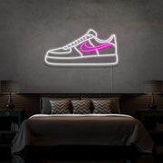 hot pink air force 1 nike sneaker neon sign hanging on bedroom wall