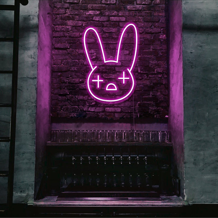 hot pink bad bunny neon sign hanging on bar wall