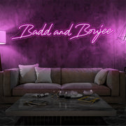 hot pink bad and boujee neon sign hanging on living room wall