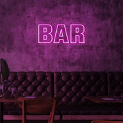 hot pink bar neon sign hanging on bar wall