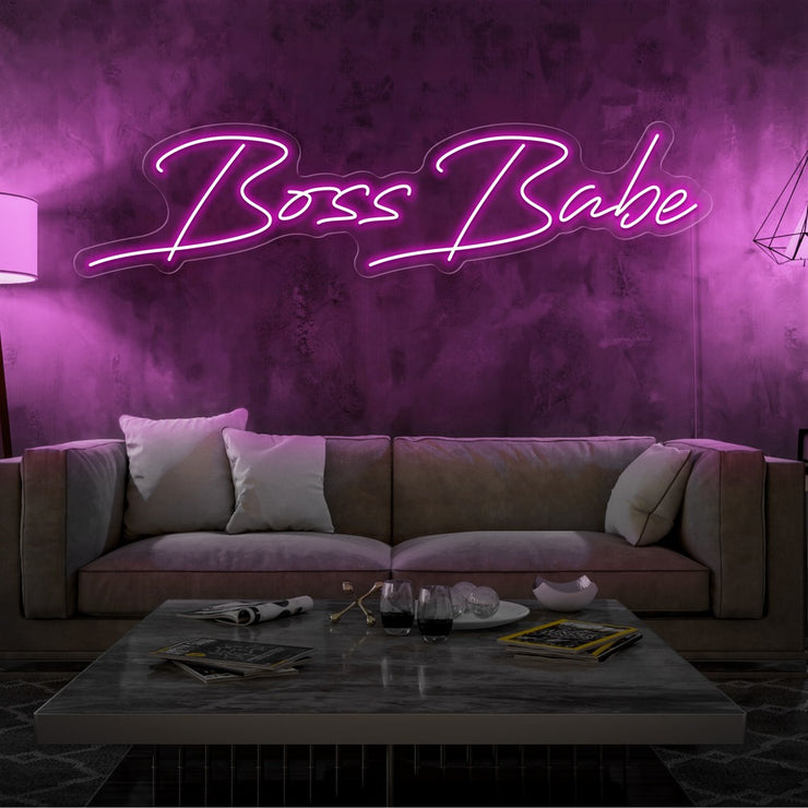 hot pink boss babe neon sign hanging on living room wall