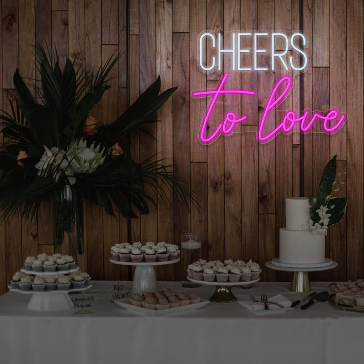 hot pink cheers to love neon sign hanging above dessert table