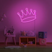 hot pink crown neon sign hanging on kids bedroom wall