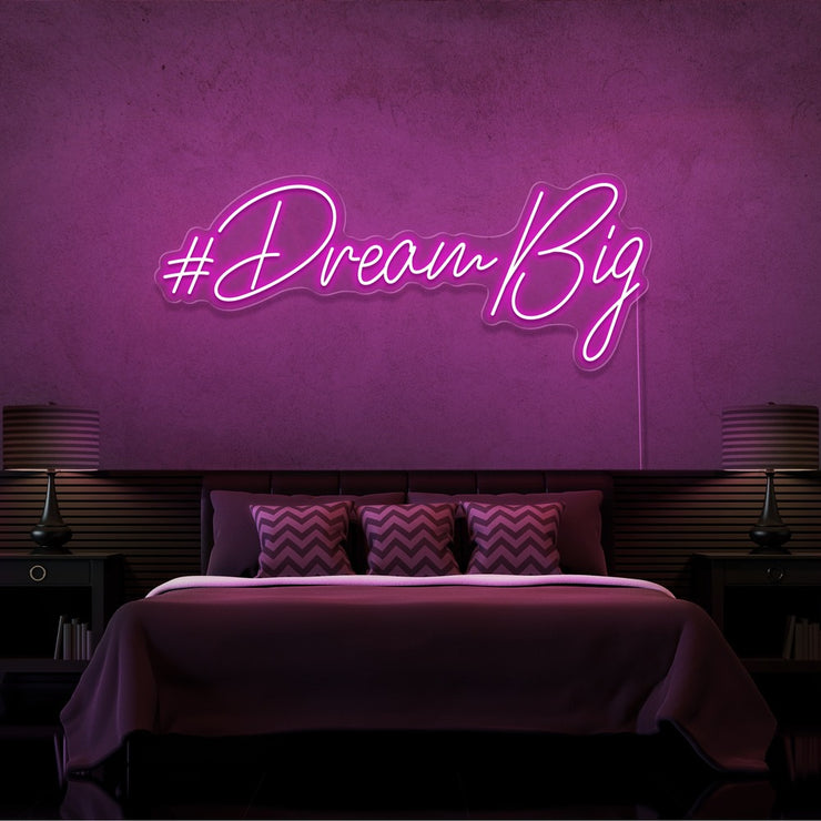 hot pink dream big neon sign hanging on bedroom wall