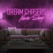 hot pink dream chasers never sleep neon sign hanging on living room wall