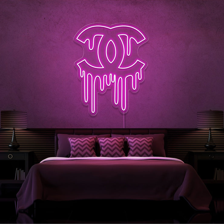 hot pink dripping chanel neon sign hanging on bedroom wall