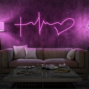 hot pink faith hope and love neon sign hanging on living room wall