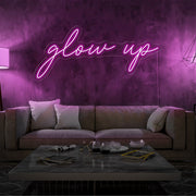 hot pink glow up neon sign hanging on living room wall