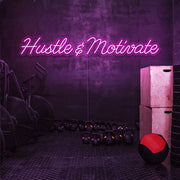 hot pink hustle and motivate neon sign hanging on gym wall