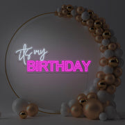 hot pink it's my birthday neon sign hanging in gold hoop backdrop with balloons