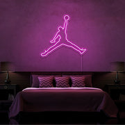 hot pink jordan jumpman neon sign hanging on bedroom wall