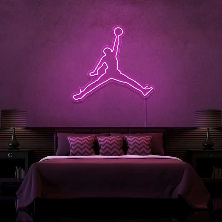 hot pink jordan jumpman neon sign hanging on bedroom wall