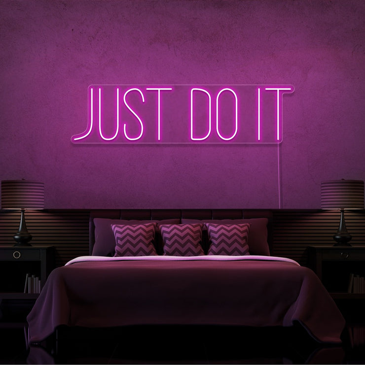 hot pink just do it neon sign hanging on bedroom wall