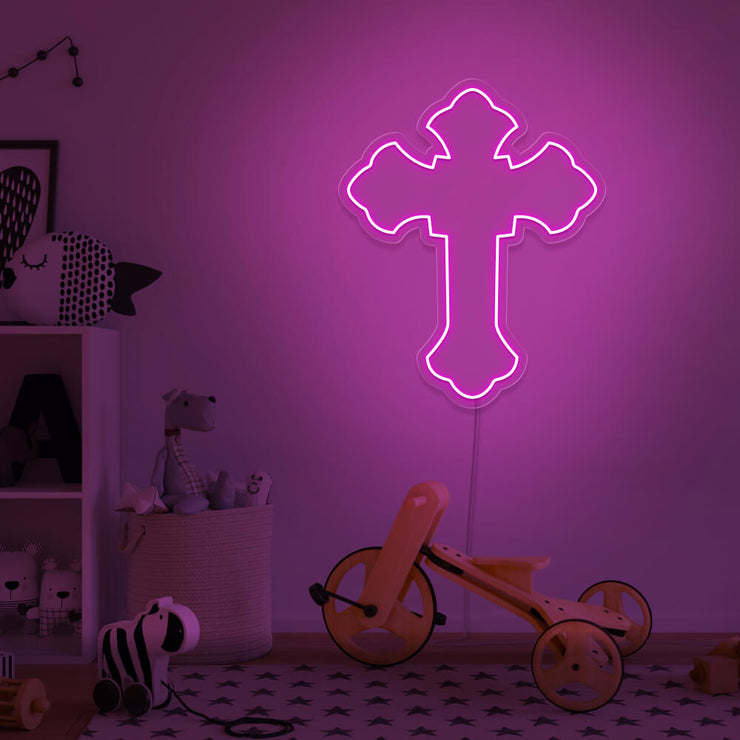 hot pink cross neon sign hanging on kids bedroom wall