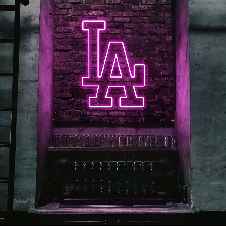 hot pink LA neon sign hanging on bar wall