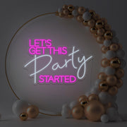 hot pink lets get this party started neon sign hanging in gold hoop frame