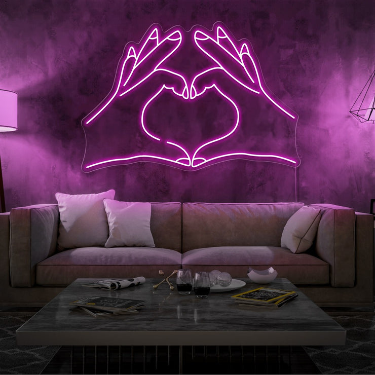 hot pink love hands neon sign hanging on living room wall