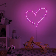 hot pink love heart neon sign hanging on kids bedroom wall