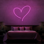 hot pink love heart neon sign hanging on bedroom wall