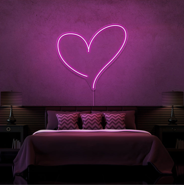hot pink love heart neon sign hanging on bedroom wall
