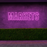 hot pink markets neon sign hanging on outside wall