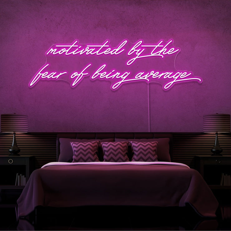 hot pink motivated by the fear of being average neon sign hanging on bedroom wall