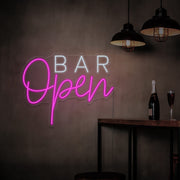 hot pink open bar neon sign hanging on bar wall